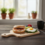 Bagel with smoked salmon and cream cheese, sunny-side-up egg with spinach, and fresh fruits on wooden board.