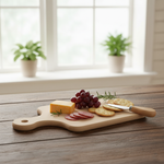 Cheese, sliced salami, grapes, crackers, and knife on wooden cutting board.
