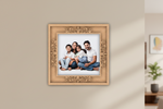 Decorative photo frame with a family portrait on a beige wall.