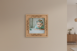 Decorative mdf picture frame with a baby photo on a beige wall.