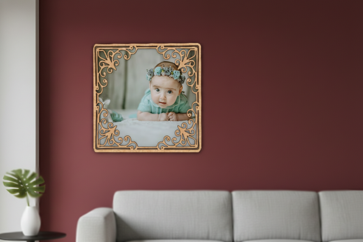 Decorative photo frame with a baby photo on a red wall above a gray sofa.