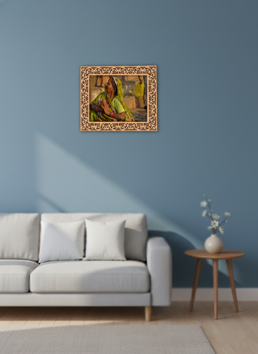 photo frame on a blue wall above a sofa with a side table and decorative vase.
