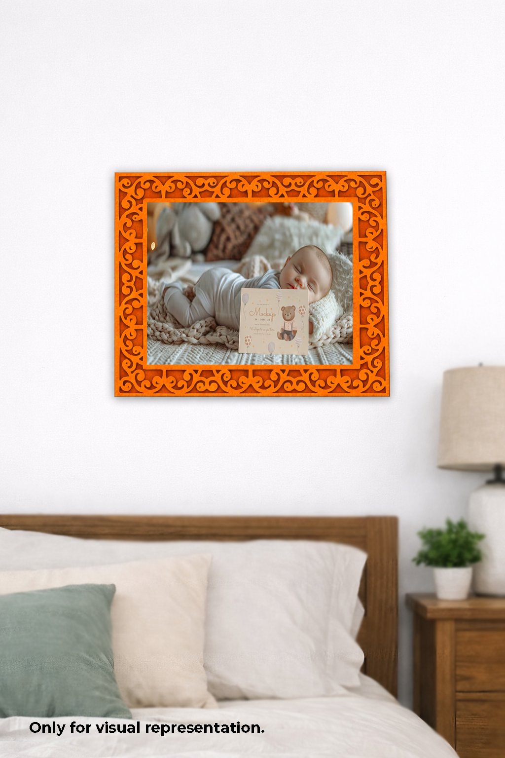 Decorative orange frame with a baby lying on a blanket inside, placed above a bed.
