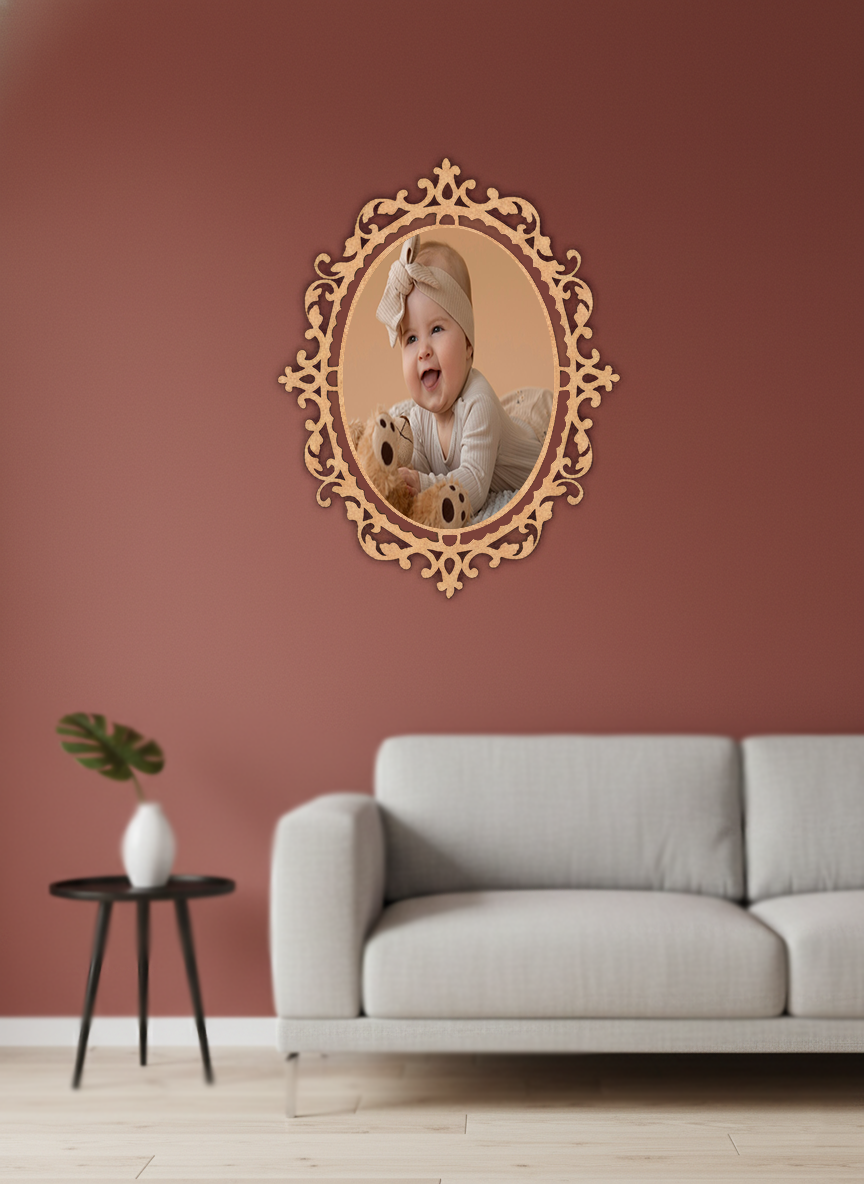 Decorative photo frame with a child's photo on a pink wall above a gray sofa.