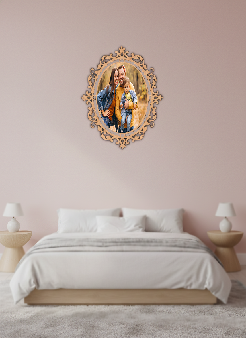 Decorative photo frame with a family photo in an ornate frame above a bed in a bedroom.