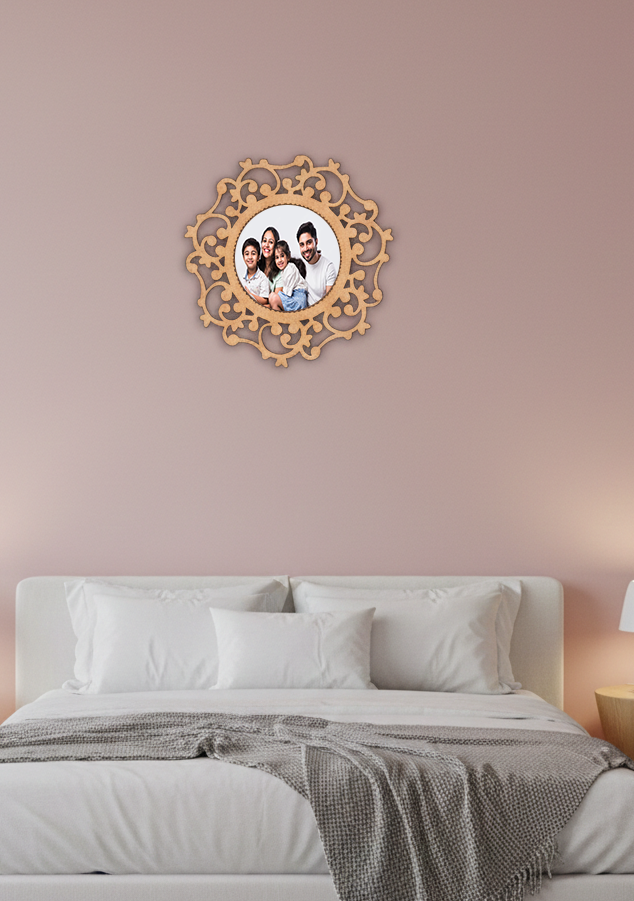 Decorative photo frame with family photo on a pink wall above a bed