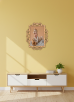 Decorative photo frame with a photo of a baby and teddy bear on a yellow wall above a white cabinet.