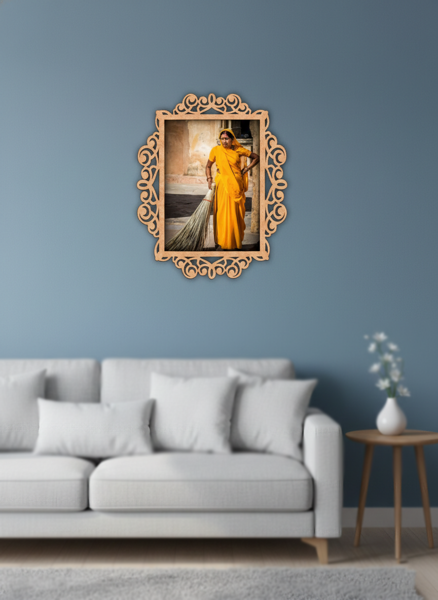 Decorative photo frame with a photo of a woman in a yellow saree on a blue wall above a gray sofa.