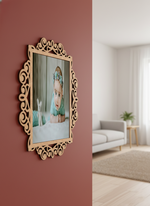 Decorative photo frame with intricate design on a red wall, showing a blurred reflection of a living room.