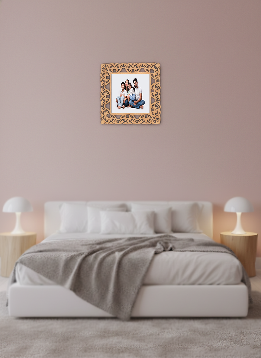 Decorative photo frame with a family picture on a wall above a bed in a bedroom.