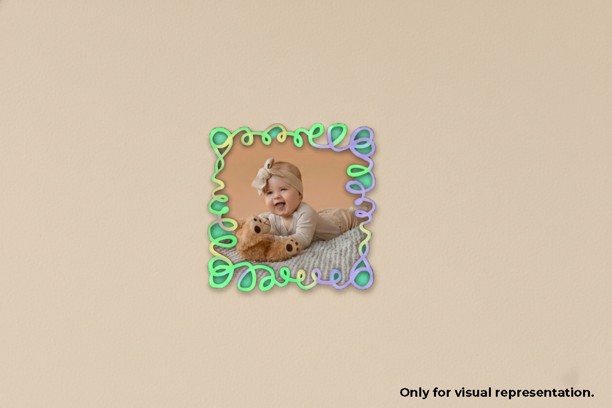Baby with a teddy bear inside a decorative green photo frame on a beige background