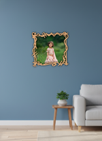 Framed photo of a child on a blue wall above a sofa and side table.