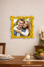 Yellow decorative frame with a couple's photo on a wall above a dining table.
