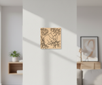 Decorative  MDF DIY wall art of an elephant with leaves on a white wall in a living room.
