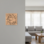 Decorative  MDF DIY wall art on a gray wall in a living room with a sofa and coffee table.