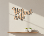 Unpainted MDF You And Me quote DIY cutout for wall decor and craft projects, mounted on wall