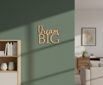 Unpainted MDF Dream Big quote DIY cutout for wall decor and craft projects, mounted on wall