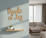 Unpainted MDF Bundle Of Joy quote DIY cutout for wall decor and craft projects, mounted on wall