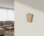 MDF DIY  wall art decoration of a baby on a light-colored wall in a living room.