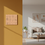 Living room with a MDF DIY  wall art piece on a mustard yellow wall and a sofa with abstract art in the background.