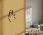 Decorative MDF DIY wall art of a hanuman on a mustard yellow wall with a living room in the background.