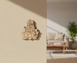  MDF DIY wall decor of a seated figure on a lotus flower against a beige wall with a blurred living room in the background.