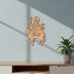  MDF DIY wall art of a deity on a bull against a light blue wall with a plant in the corner.