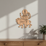  MDF DIY  wall art of a deity on a lion against a white wall with a plant in the corner.