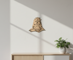  MDF DIY  wall art of a face on a white wall with a plant in the corner