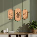 Three decorative  MDF DIY  wall hangings on a green wall with a plant and shelf in the foreground.