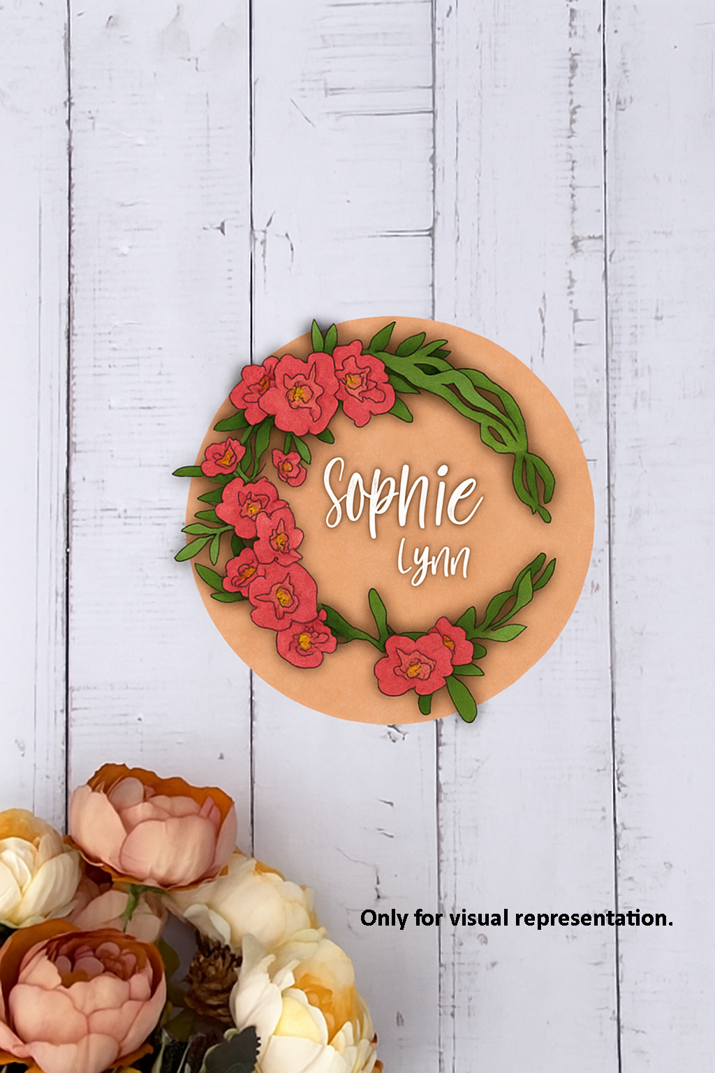 Painted MDF round floral name plate with custom name “Sophie Lynn.”