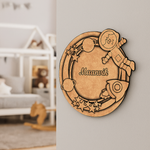 Decorative DIY MDF wall plaque with space-themed design and 'Maanik' engraving in a room setting.
