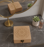 MDF box with mandala design on a marble surface with a mirror and plants in the background.