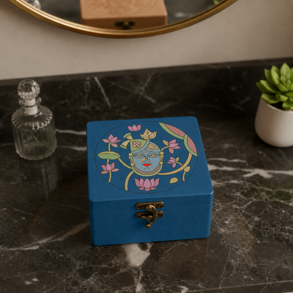 Blue MDF lock box with shreenathji design kept on a marble surface