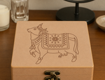 DIY MDF Lock box with a pichwai cow illustration on a wooden surface