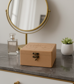 MDF jewelry box on a marble surface with a mirror and plant in the background