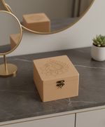 MDF box with floral design on a marble surface with a mirror and plant in the background