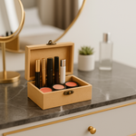 Open beige jewelry box with makeup items on a marble surface