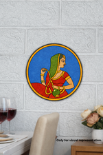 Decorative MDF DIY wall art of a woman in a red saree with a green headscarf on a textured white wall.