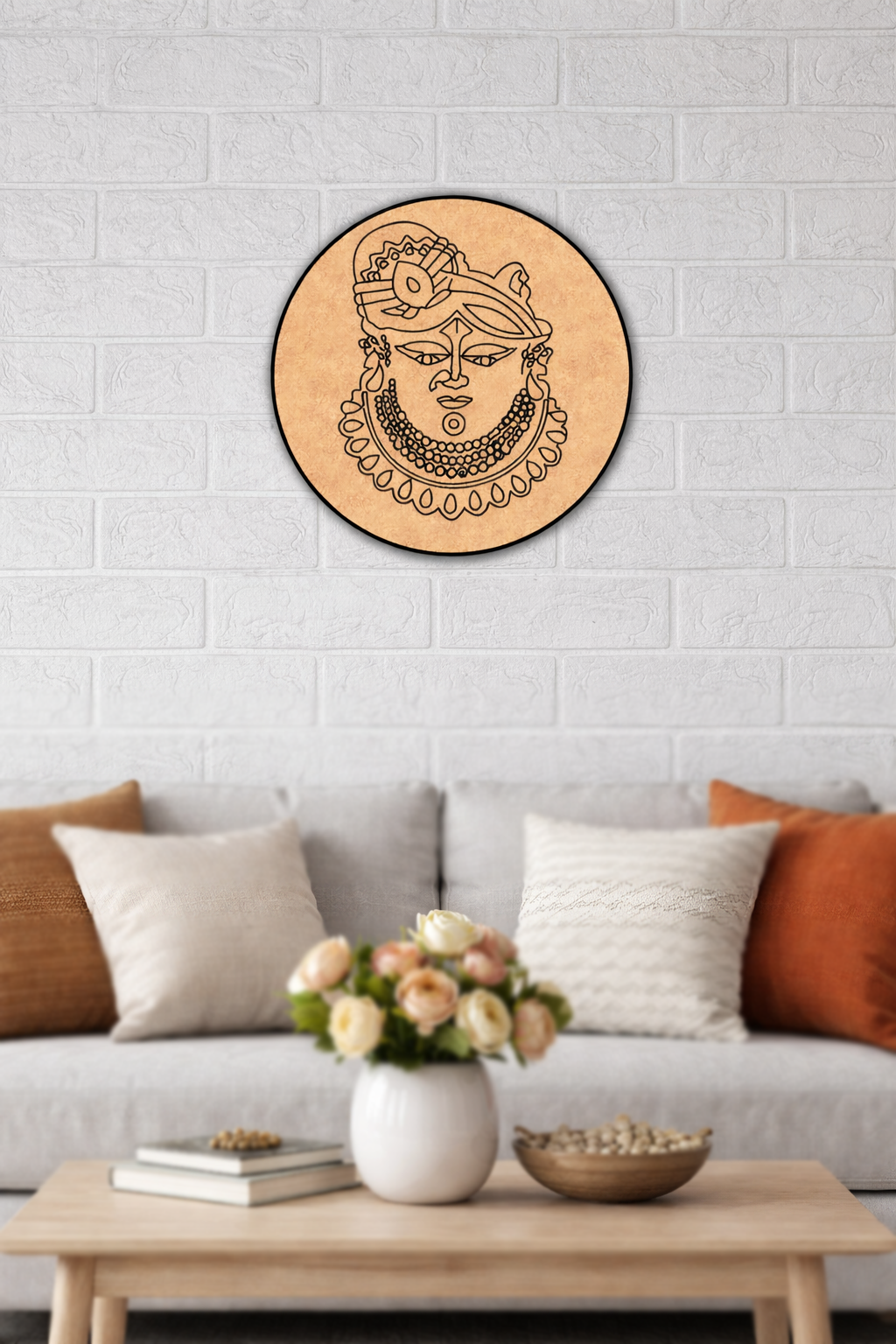 Decorative MDF DIY  wall art of a face on a wooden circle above a sofa with a coffee table and flowers.
