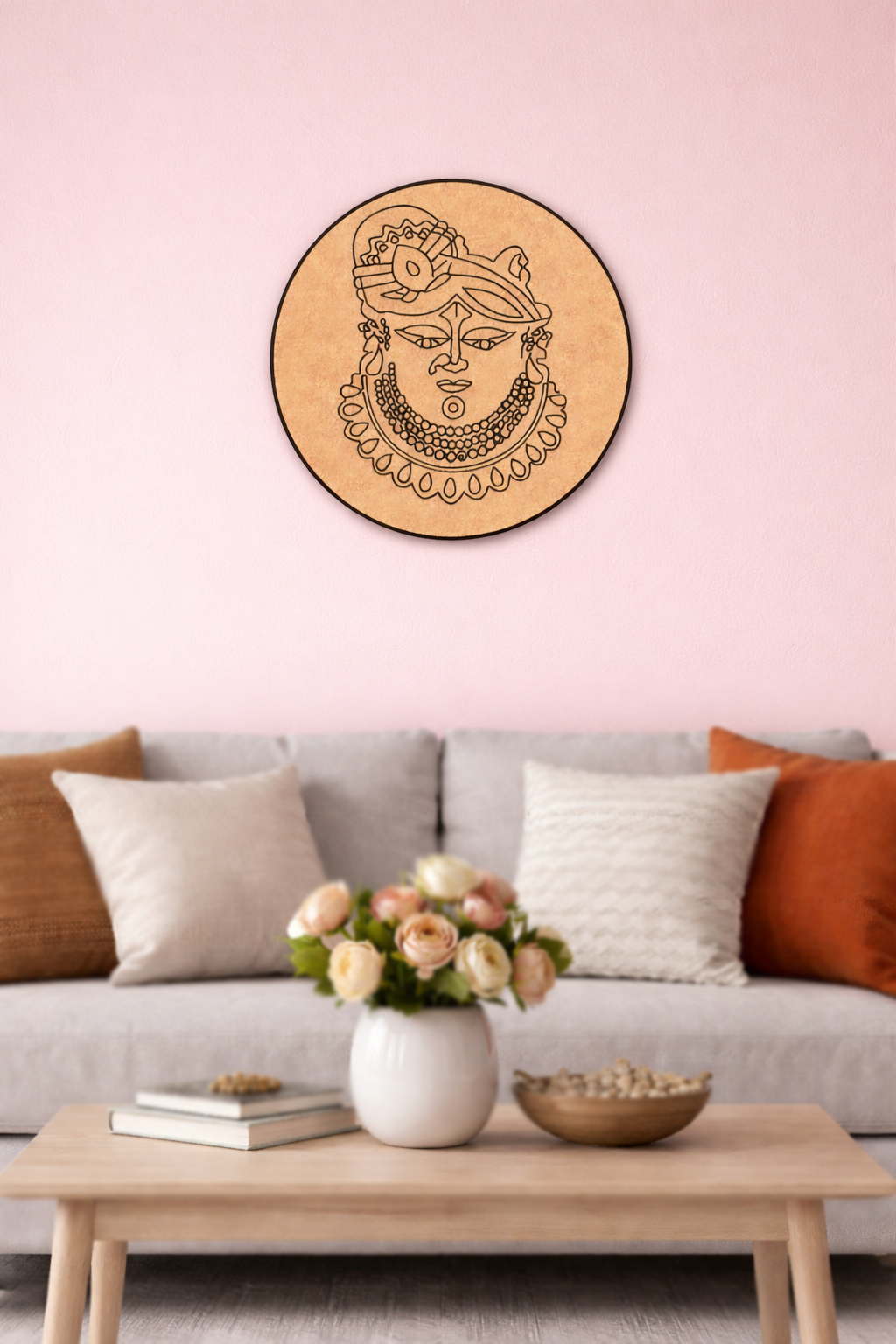 Decorative MDF DIY  wall piece on a pink wall above a gray sofa with colorful cushions.