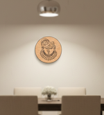 Decorative MDF DIY wall art with a circular design of a face on a beige wall above a dining table.
