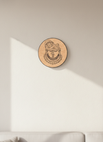Round MDF DIY  wall art with a face design on a beige wall.