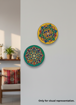 Two colorful MDF DIY wall art pieces with geometric patterns on a gray wall.