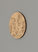MDF DIY wall art with intricate carvings of two faces on a gray background