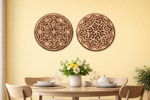Decorative MDF DIY wall art pieces on a yellow wall above a dining table with a floral arrangement.