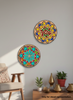 Two colorful circular MDF DIY wall art decorations on a gray wall with a chair and plants in the background.