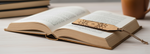 Open book with a decorative MDF DIY  bookmark on a light surface