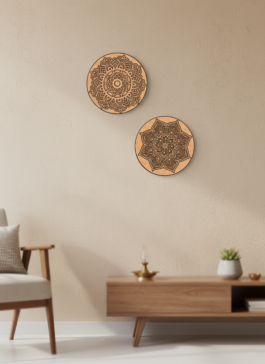 Two decorative MDF DIY wall hangings with mandala patterns on a beige wall above a wooden coffee table.