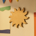 Plain MDF sun shape wall hanging displayed on a decorated bulletin board